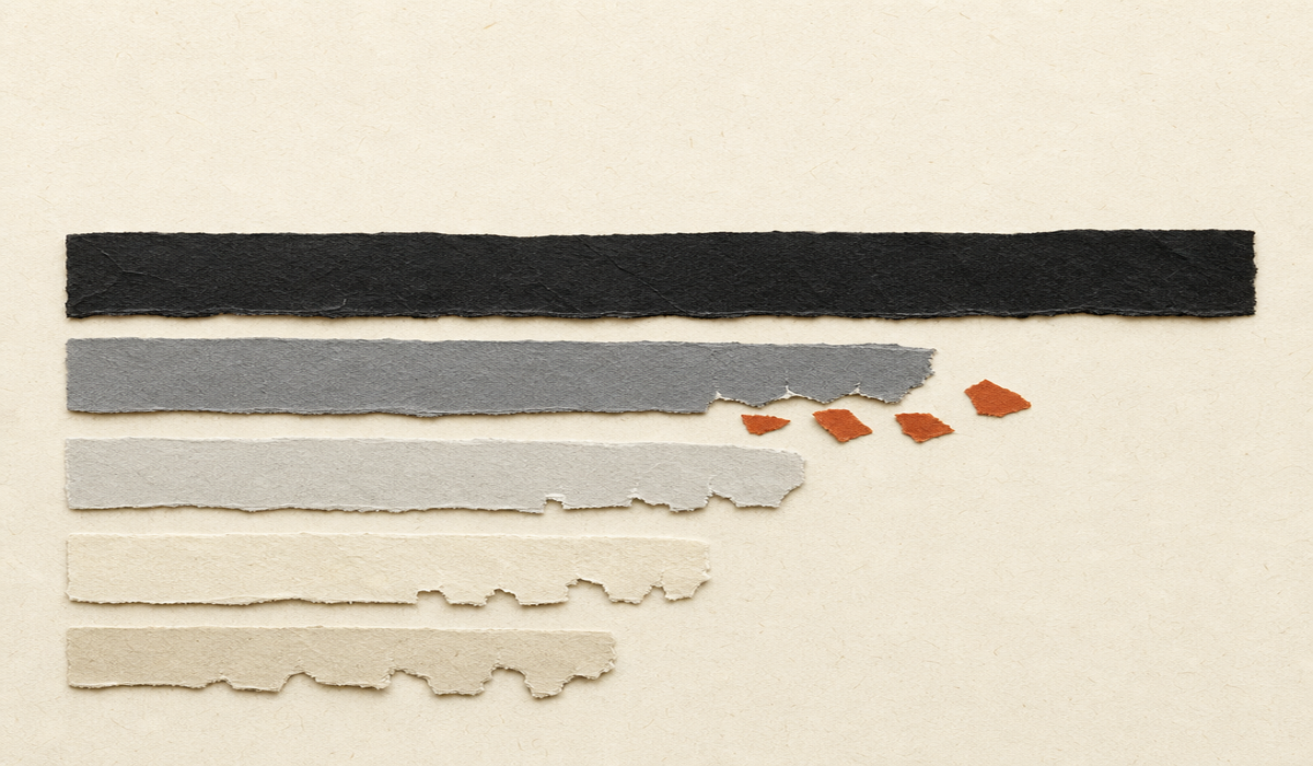 Cut-paper collage of a long black paper band beside a shorter gray band, with small terracotta fragments slipping out through tears along the gray band’s edge.